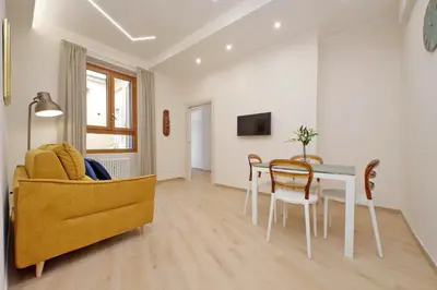 a living room with a couch and a table and chairs at 4BNB - Ottaviano Vatican Flat in Rome