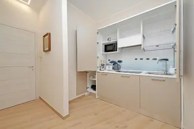 a kitchen with white cabinets and a sink at 4BNB - Ottaviano Vatican Flat in Rome