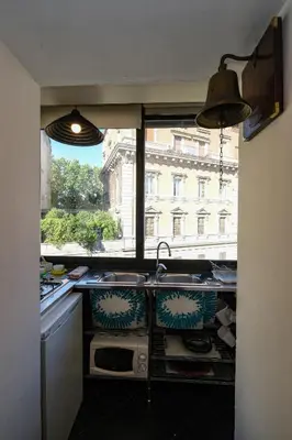 a kitchen with a sink and a window at Trastevere Characteristic Roman Home in Rome