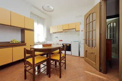 a kitchen with a table and chairs in a room at Etruria At San Giovanni by Halldis in Rome