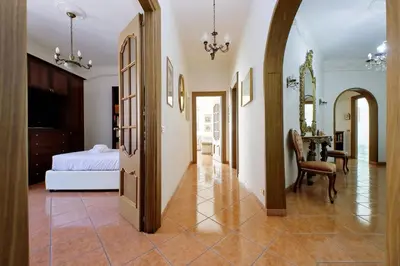 a bedroom with a bed and a table and a chair at Etruria At San Giovanni by Halldis in Rome