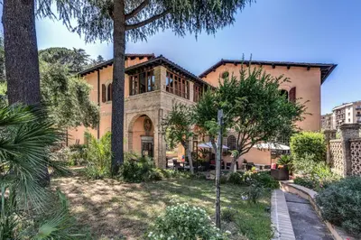 a large brick house with trees in a yard at Villa Alberici in Rome