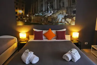 a hotel room with a bed with towels on it at Domus Viatoris in Rome
