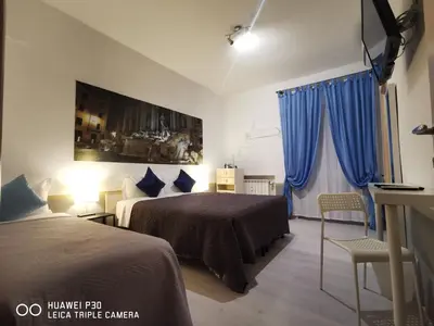 a bedroom with a bed and a picture of a building at Domus Viatoris in Rome
