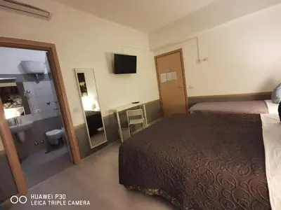 a bedroom with a bed with a large painting on the wall at Domus Viatoris in Rome