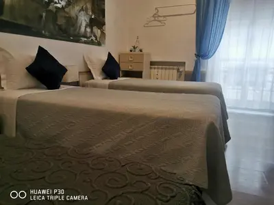 a bedroom with a bed with a large painting on the wall at Domus Viatoris in Rome