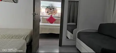 a bedroom with a mirror and a bed and a window at Domus Viatoris in Rome