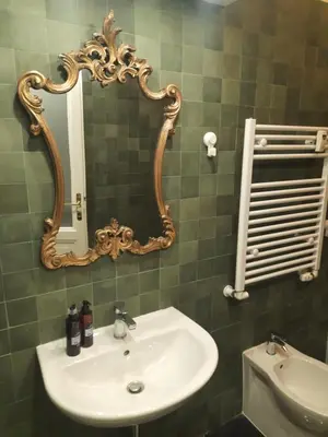 a bathroom with a sink and a mirror on the wall at Delizioso appartamento al Pigneto in Rome