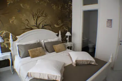 a bedroom with a large white bed with pillows at Conny's Home in Rome
