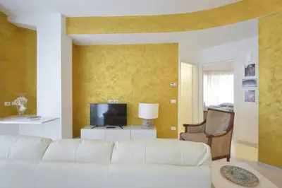 a living room with a white couch and a television at Conny's Home in Rome