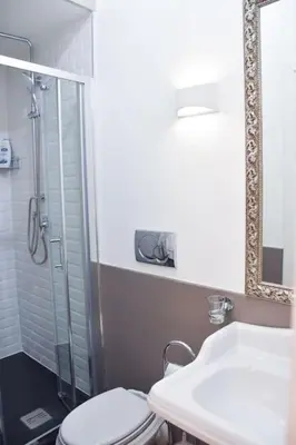a bathroom with a shower and a toilet and a sink at Spanish Steps-Trevi -Luma Suite in Rome