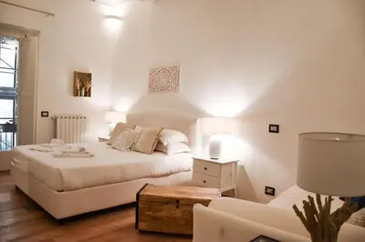 a white bedroom with a bed and a couch at Spanish Steps-Trevi -Luma Suite in Rome