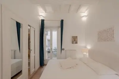 a white bedroom with a large bed and a window at Spanish Steps-Trevi -Luma Suite in Rome
