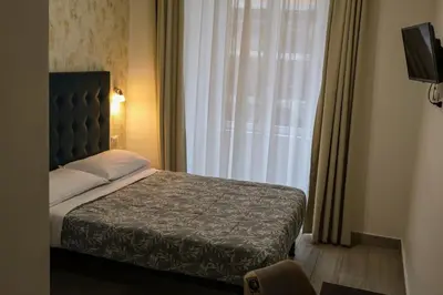 a bedroom with a bed in front of a window at Nives House Roma in Rome