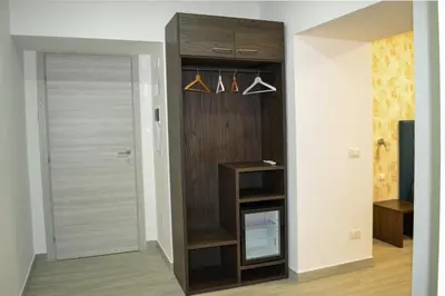 a room with a closet with hangers and a door at Nives House Roma in Rome