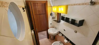 a small bathroom with a sink and a toilet at La Casetta con giardino al Pigneto in Rome