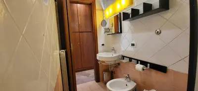 a bathroom with a toilet and a sink at La Casetta con giardino al Pigneto in Rome