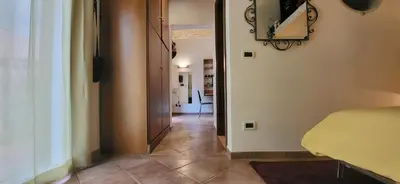 a room with a hallway with a room with a bed at La Casetta con giardino al Pigneto in Rome