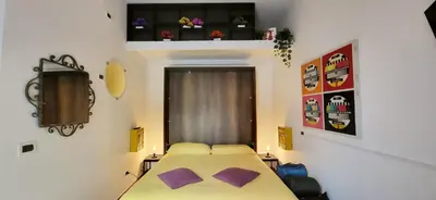 a small room with a bed and a window at La Casetta con giardino al Pigneto in Rome