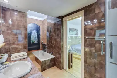 a bathroom with a sink and a tub and a shower at Guest House Il Limone Nascosto in Rome