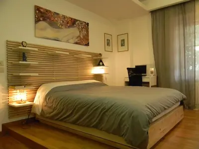 a bedroom with a large bed and a desk at Guest House Il Limone Nascosto in Rome