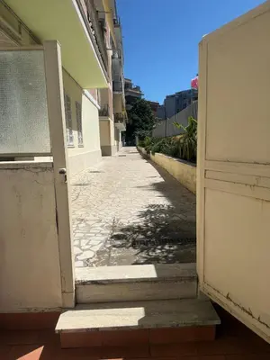 an open door to a building on a sidewalk at Mon-Tis Paolo V - vicino metro Cornelia in Rome