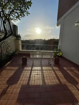 a bench on a balcony with the sun in the background at Mon-Tis Paolo V - vicino metro Cornelia in Rome