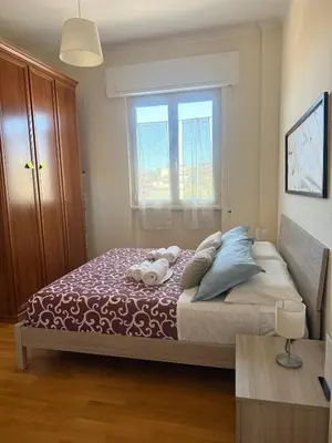 a bedroom with a large bed with a window at Mon-Tis Paolo V - vicino metro Cornelia in Rome