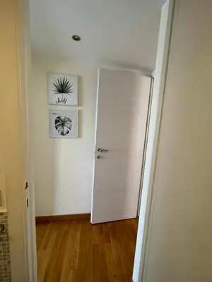 a room with a white door and a wooden floor at Mon-Tis Paolo V - vicino metro Cornelia in Rome