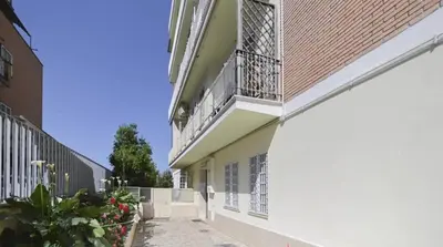 a building with a balcony on the side of it at Mon-Tis Paolo V - vicino metro Cornelia in Rome