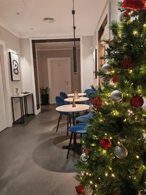 a christmas tree in a room with tables and chairs at AD Vatican Luxury Rooms - by AD Roma in Rome