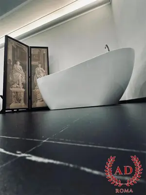 a white bowl on a table with three pictures at AD Vatican Luxury Rooms - by AD Roma in Rome