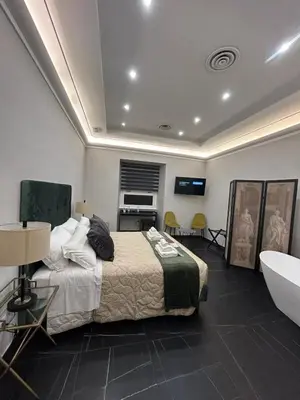 a bedroom with a bed and a tub and a sink at AD Vatican Luxury Rooms - by AD Roma in Rome
