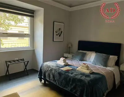 a bedroom with a bed with two towels on it at AD Vatican Luxury Rooms - by AD Roma in Rome