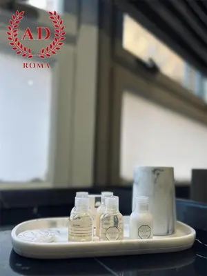 a tray with four glass bottles on a table at AD Vatican Luxury Rooms - by AD Roma in Rome