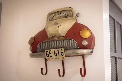 a car hanging on a wall with a license plate at Mou Trastevere House by Rental in Rome in Rome