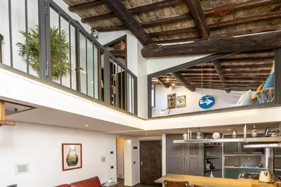 an open living room with a wooden ceiling at Mou Trastevere House by Rental in Rome in Rome