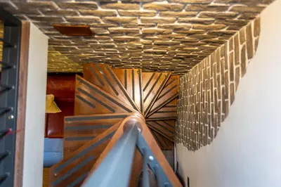 a stairwell with a wooden ceiling with a spiral staircase at Mou Trastevere House by Rental in Rome in Rome