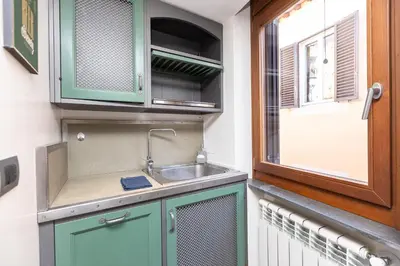 a kitchen with a sink and a window at Mou Trastevere House by Rental in Rome in Rome