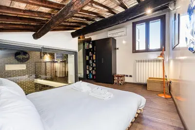 a bedroom with a large white bed in a room at Mou Trastevere House by Rental in Rome in Rome