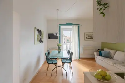 a living room with a table and a couch at iFlat Cozy flat with a view in San Giovanni in Rome