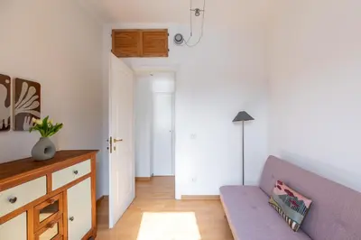 a living room with a purple couch and a table at iFlat Cozy flat with a view in San Giovanni in Rome