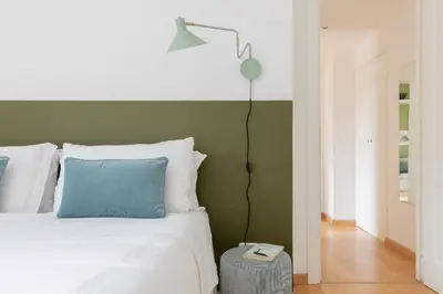 a bedroom with a white bed and a lamp at iFlat Cozy flat with a view in San Giovanni in Rome