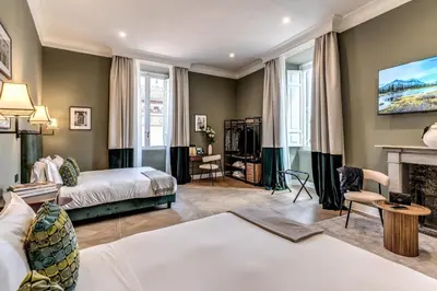 a bedroom with a bed and a fireplace at Dimore Paganica in Rome