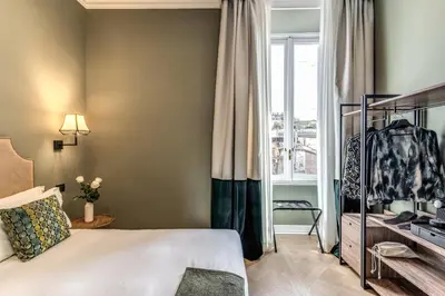 a bedroom with a bed and a window at Dimore Paganica in Rome