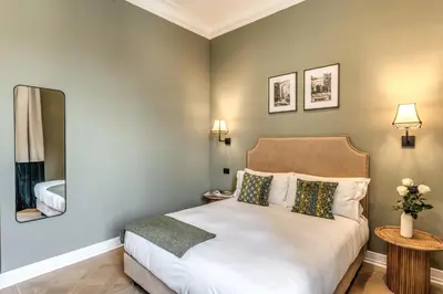 a bedroom with a bed and a mirror at Dimore Paganica in Rome