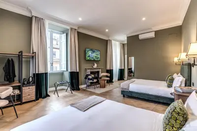 a hotel room with two beds and a fireplace at Dimore Paganica in Rome