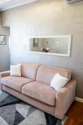 a living room with a brown couch in a room at INTERNO 39 - San Pietro in Rome
