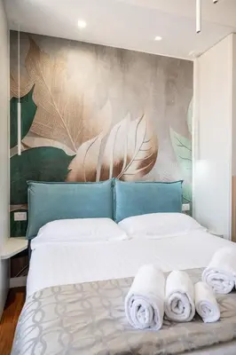 a bedroom with a large bed with towels on it at INTERNO 39 - San Pietro in Rome