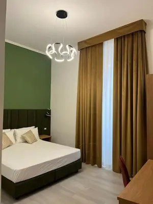 a bedroom with a bed and a chandelier at Vatican Museum Scipioni BED & Breakfast in Rome